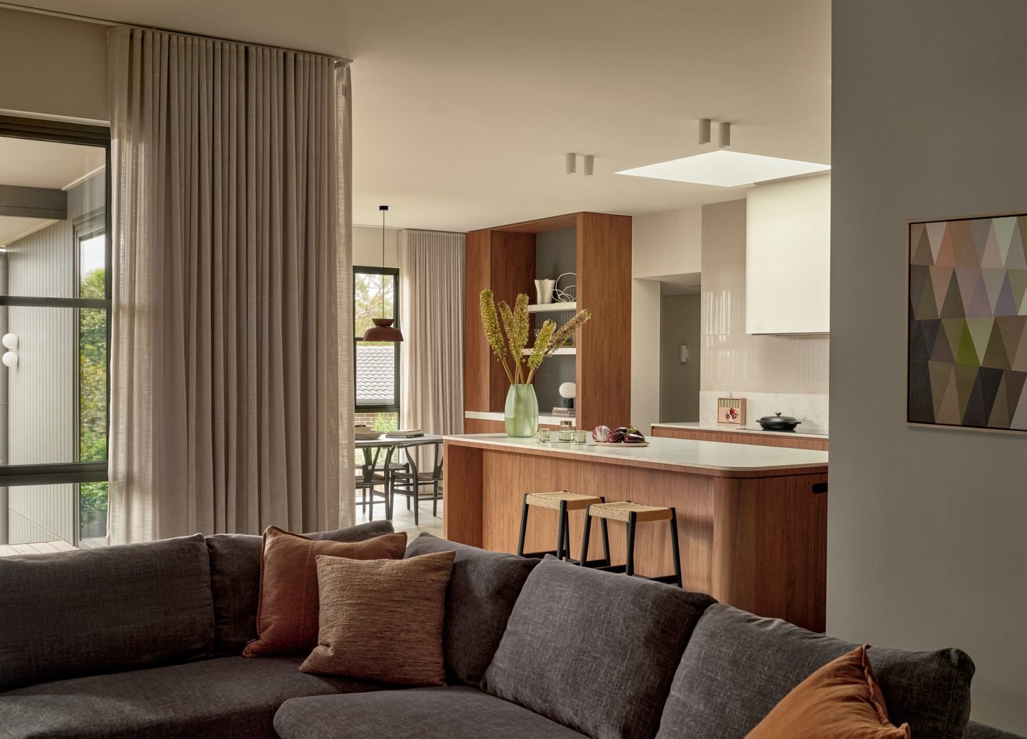 Looking from the lounge through to the kitchen, with ceiling spotlights and a skylight