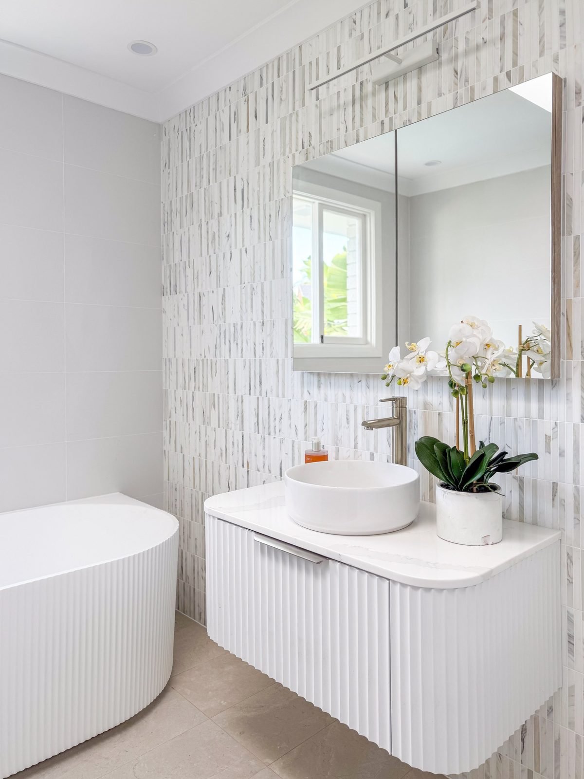 Bathroom vanity and mirror cabinet with a downlight above